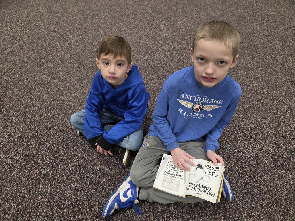 4th graders reading to 1st graders.