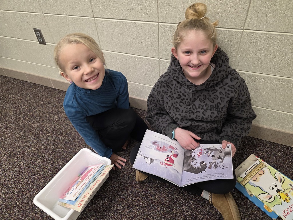 4th graders reading to 1st graders.