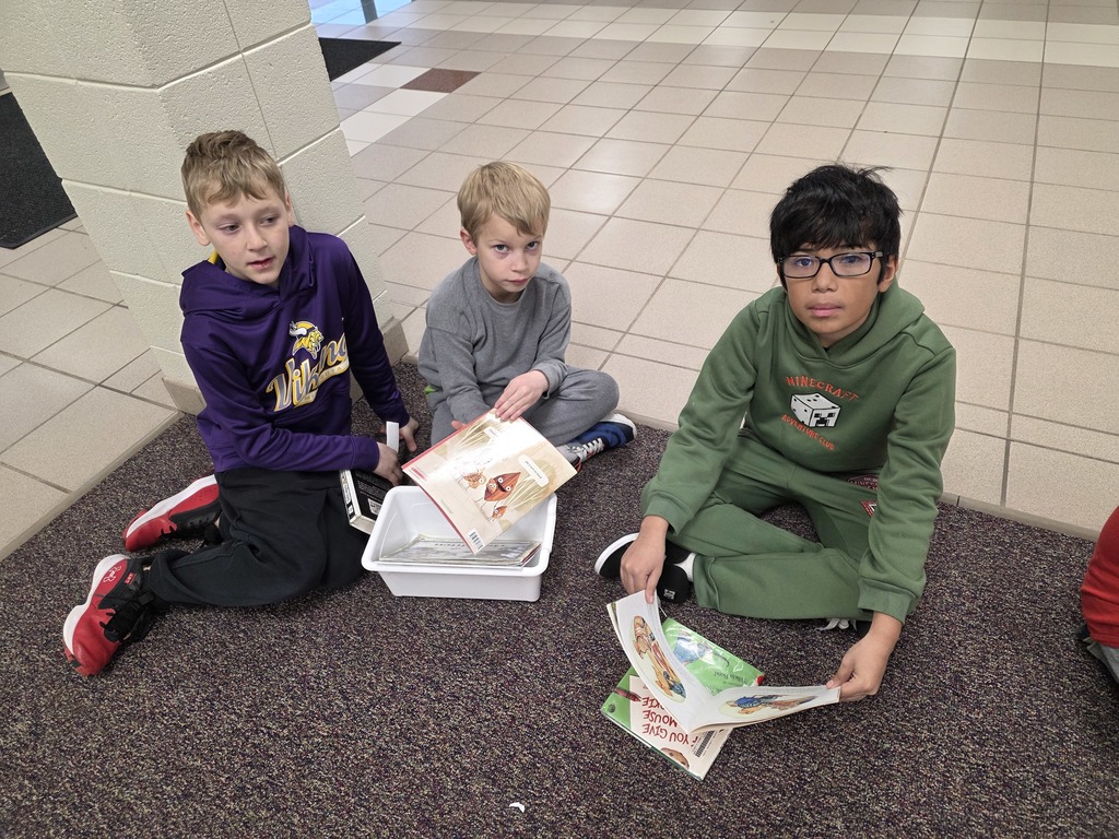 4th graders reading to 1st graders.