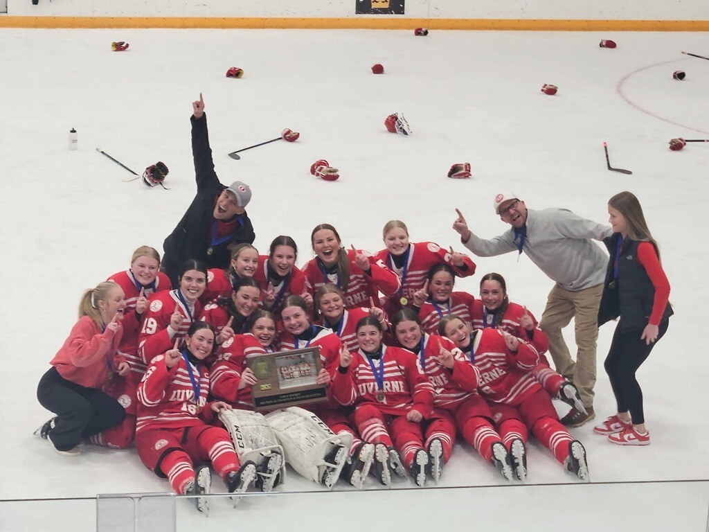 girls hockey team poses with trophy