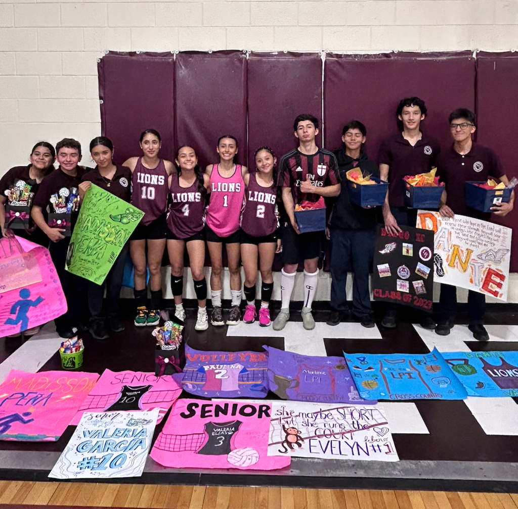 Senior Athletes posing with their posters for Senior Night.