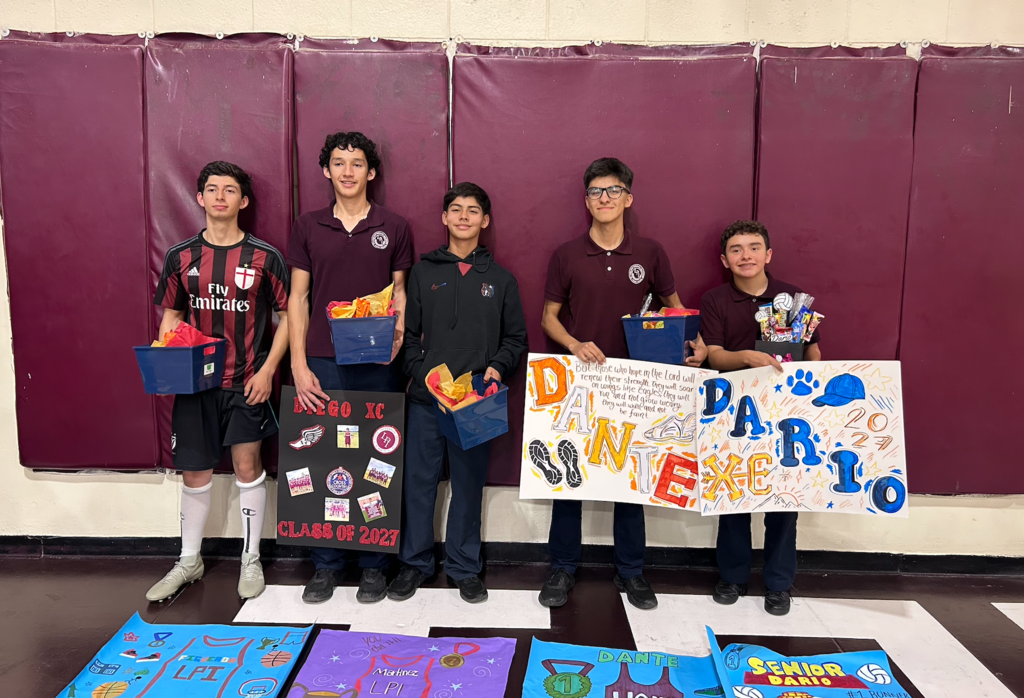 Senior Athletes posing with their posters for Senior Night.