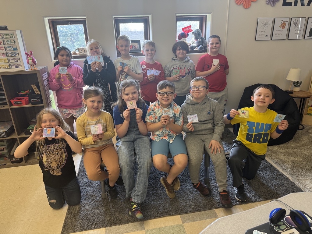 group of students holding cards