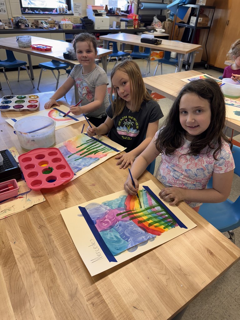 three girls painting at table