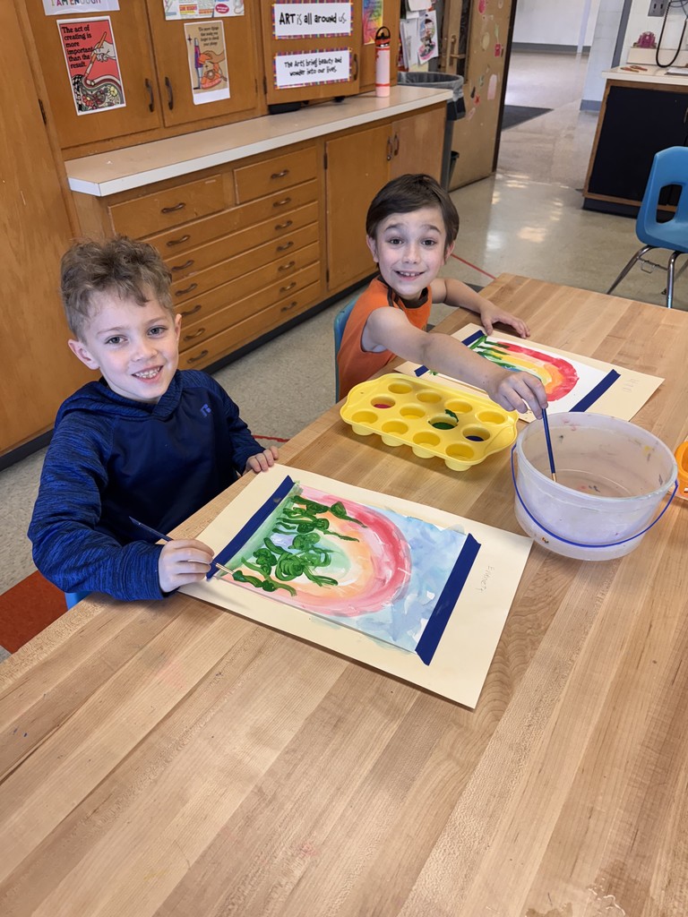 two boys painting at table