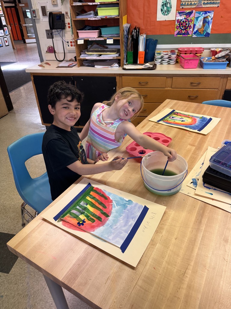 a boy and a girl painting at a table