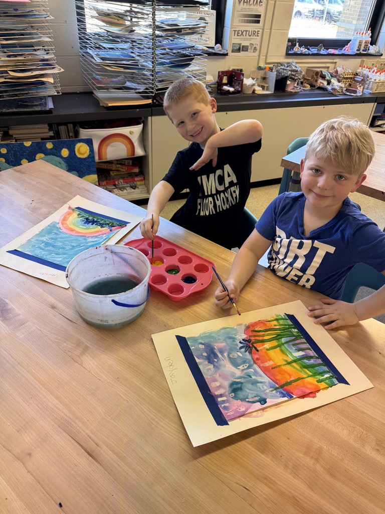 two boys painting at table