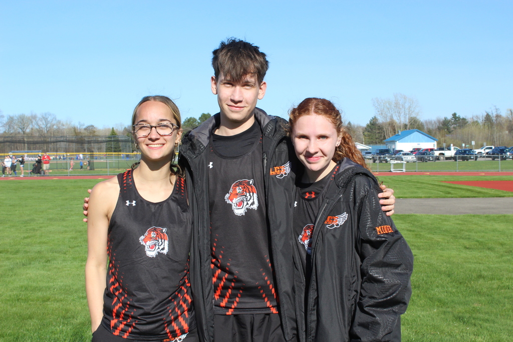 three student athletes standing together