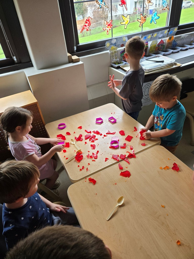 students standing around table cutting shapes out of jello