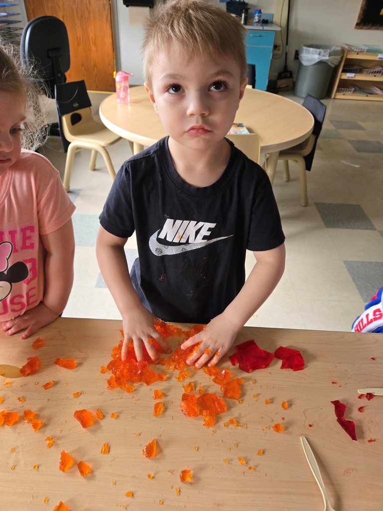 boy playing with jello shapes at table