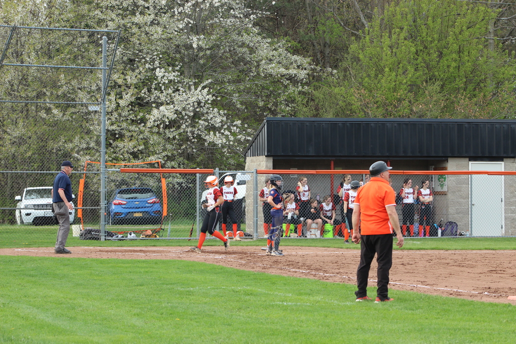 girl running to homebase in softball game