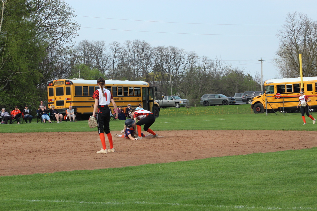 softball player tagging someone out on second base