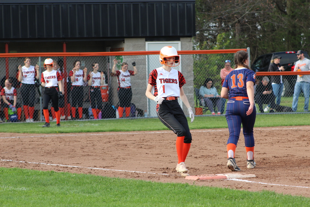 softball player running to first base