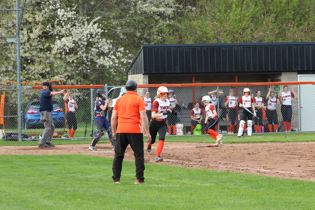 two girls running to home and first base in softball game