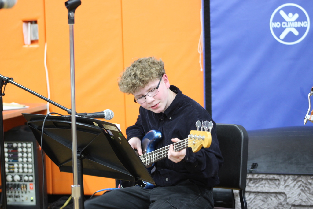 boy singing while playing guitar