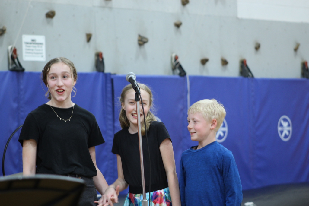 three kids singing together