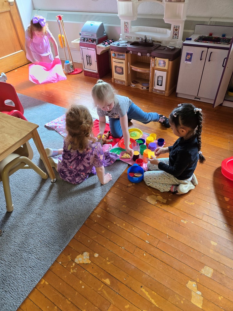 four girls playing in the kitchen area