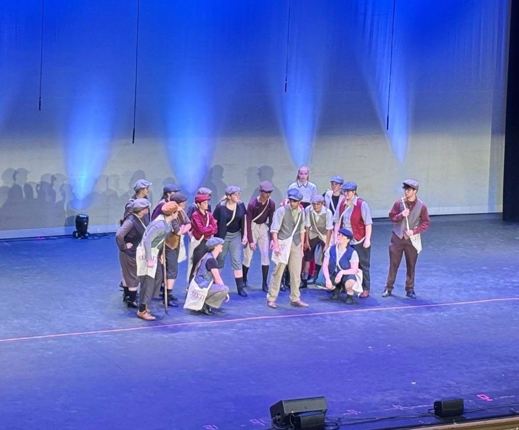students performing on stage