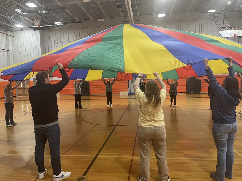 teachers holding the parachute in the air