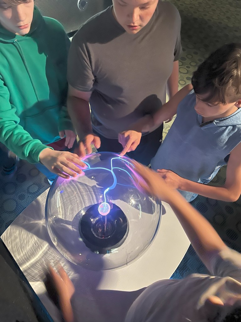 students touching a sphere at the museum