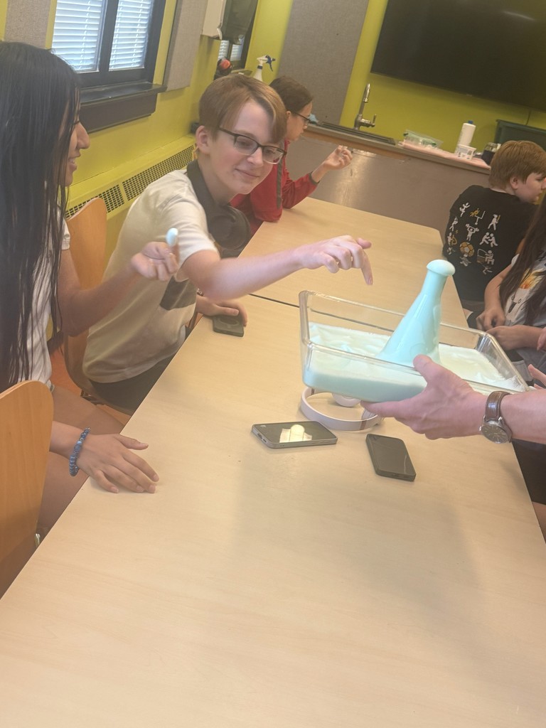 students looking a volcano experiment