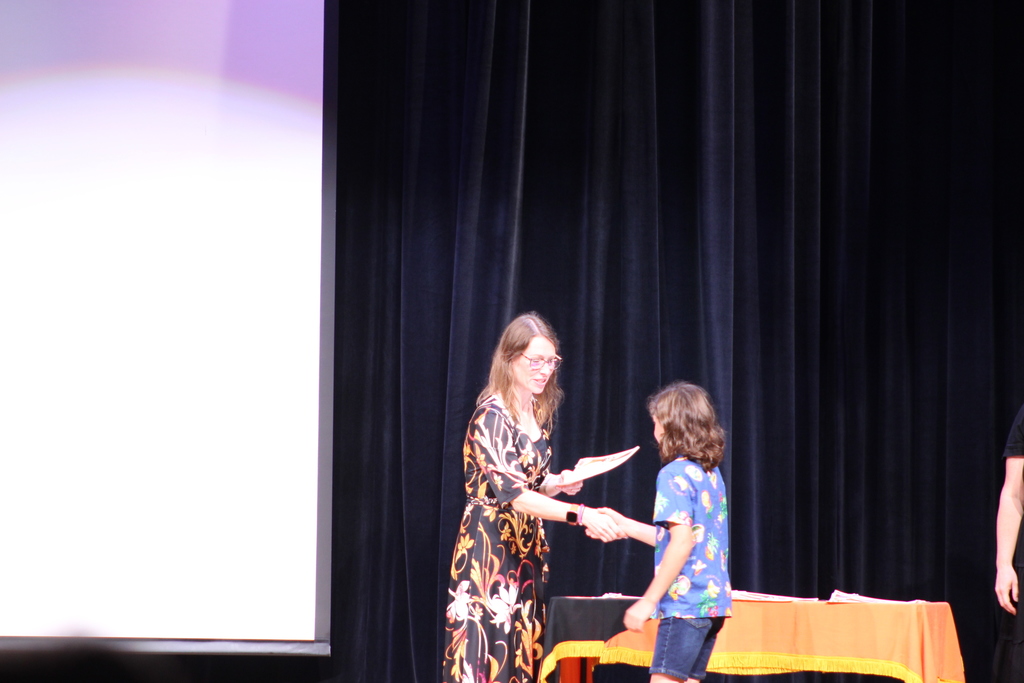 student shaking hands with principal