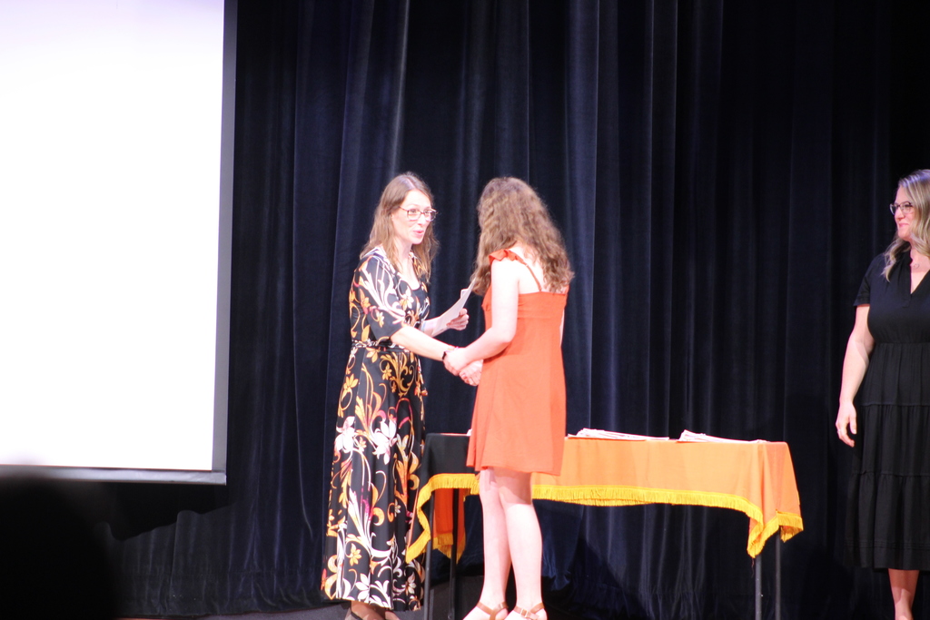 student shaking hands with principal