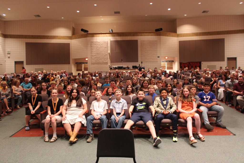 group photo of students sitting in auditorium
