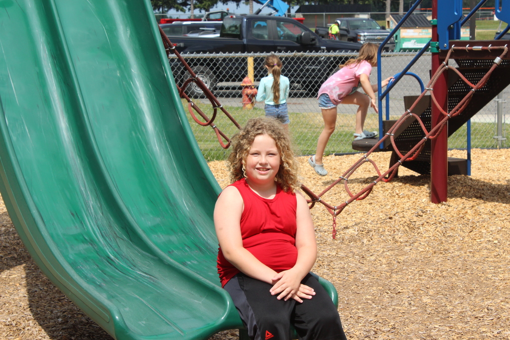 boy sitting on bottom of slide
