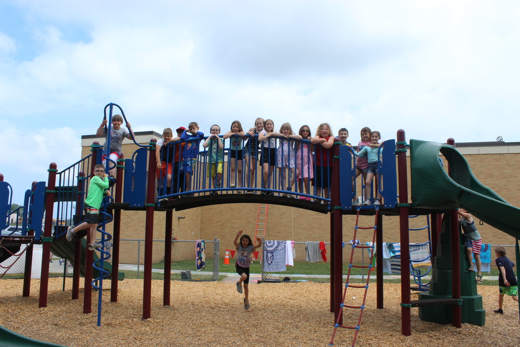 students on playground equipment outside