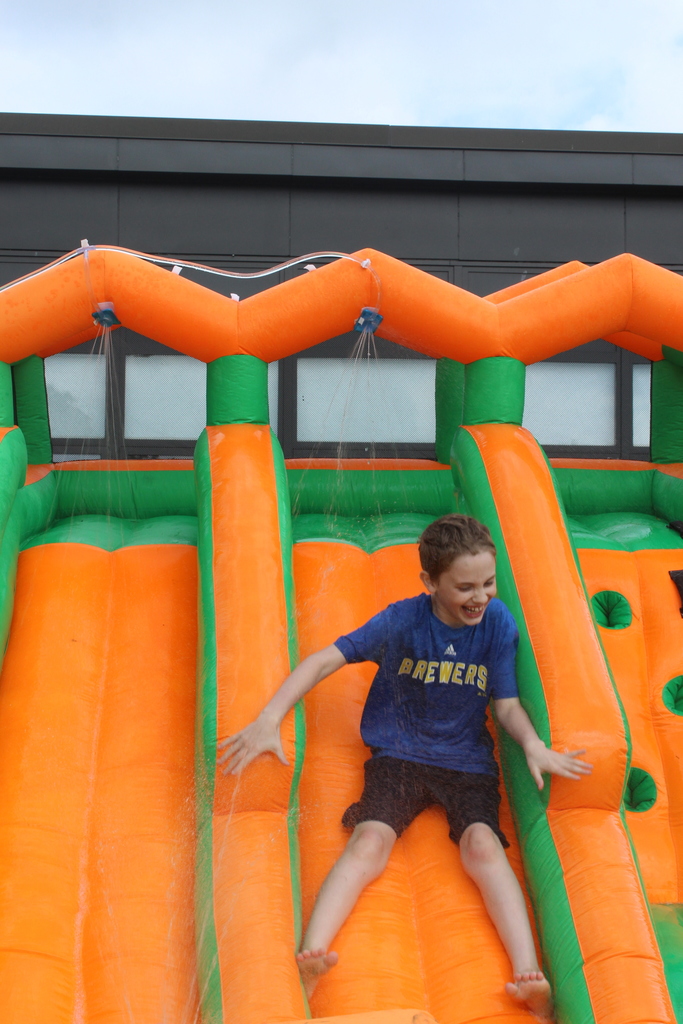 boy sliding down inflatable water slide