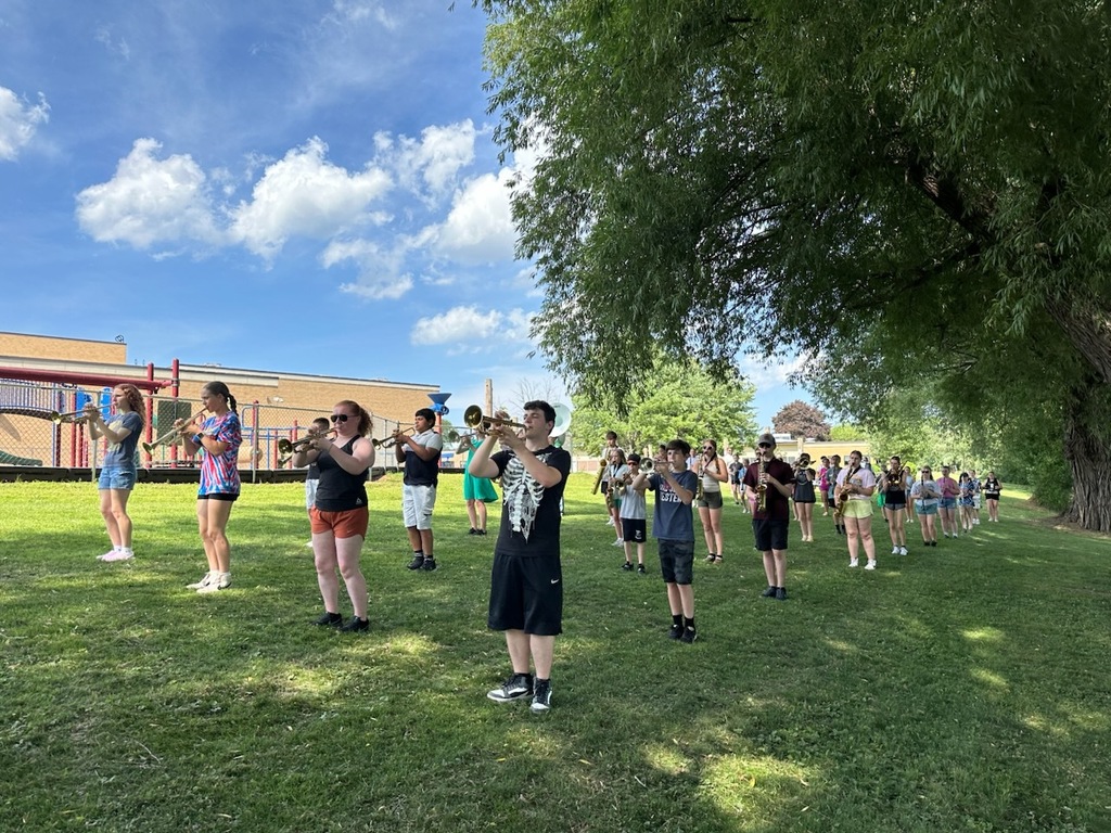 students on the lawn playing instruments