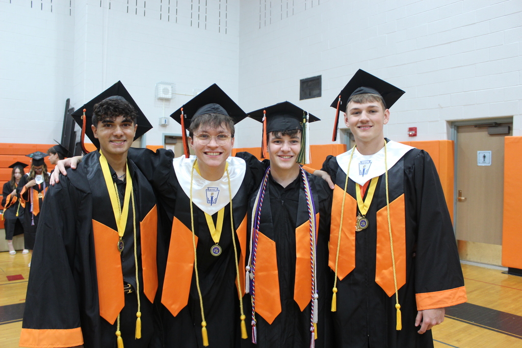 four graduating boys standing together