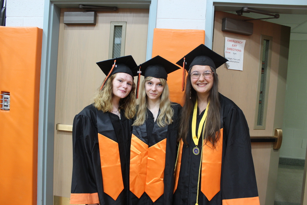 three graduating girls standing together
