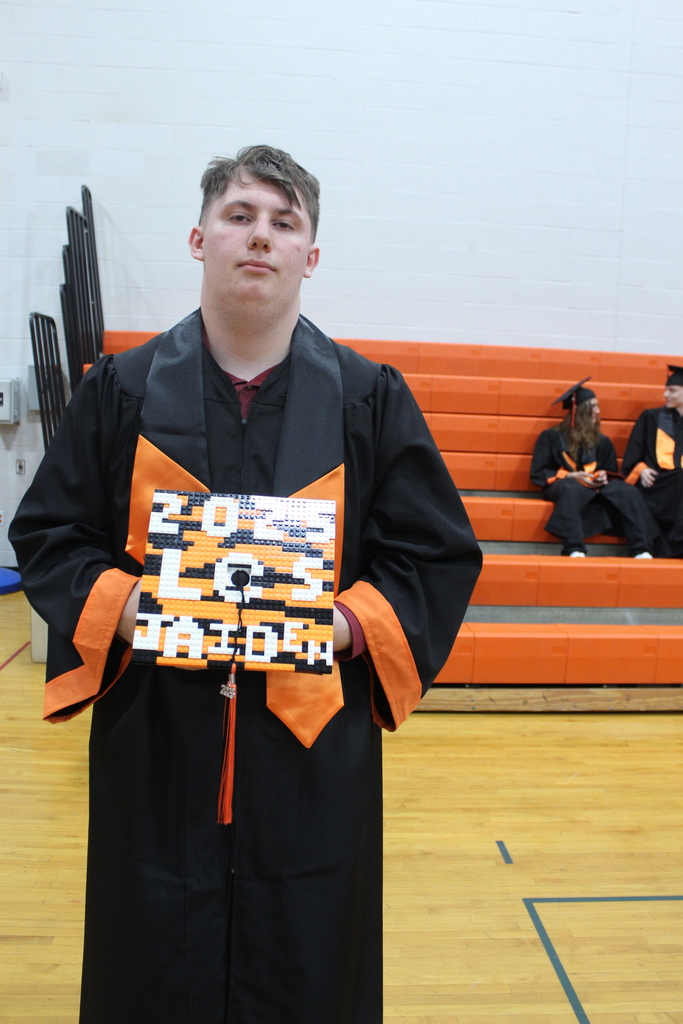 boy holding decorated cap