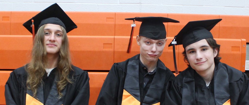 three graduating boys sitting together