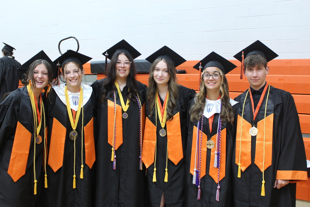 group of students standing together in caps and gowns