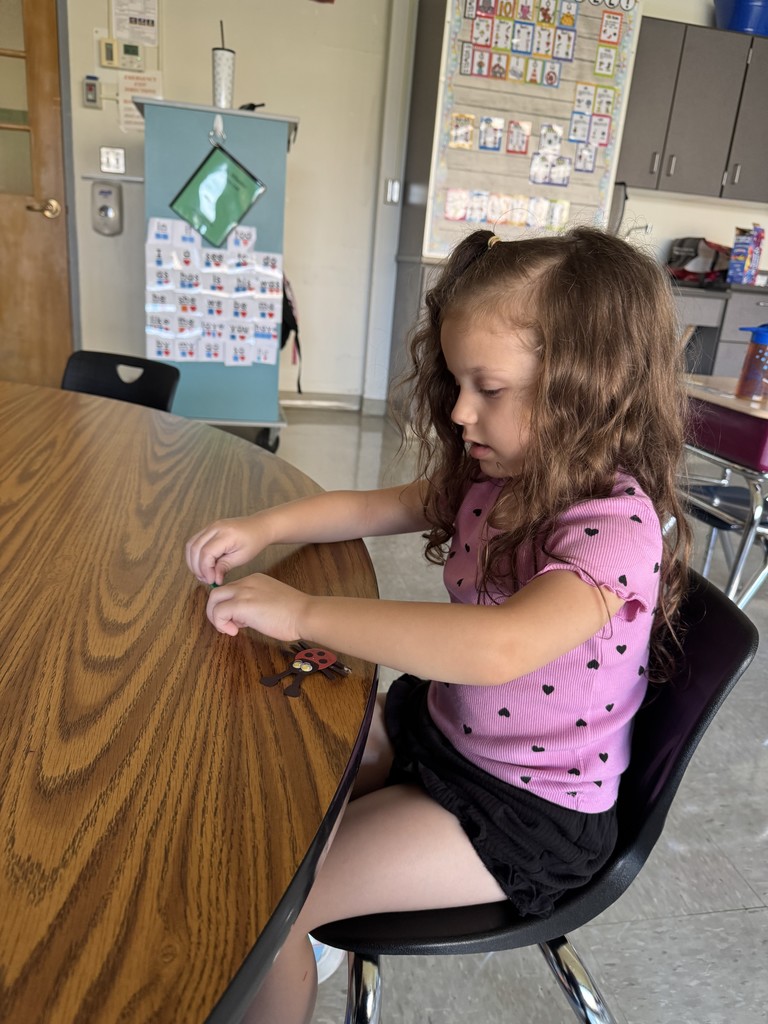 girl making craft at table