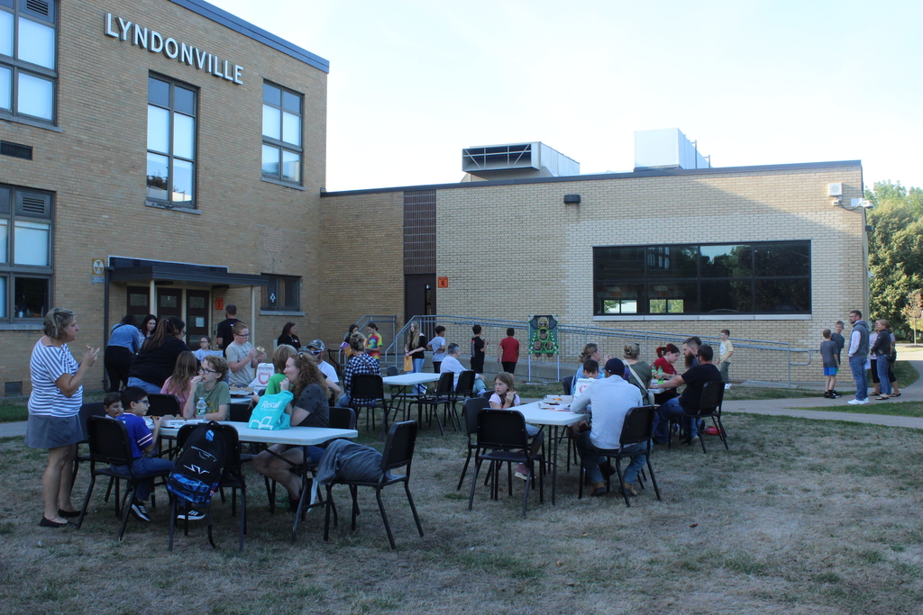 people sitting at tables eating food