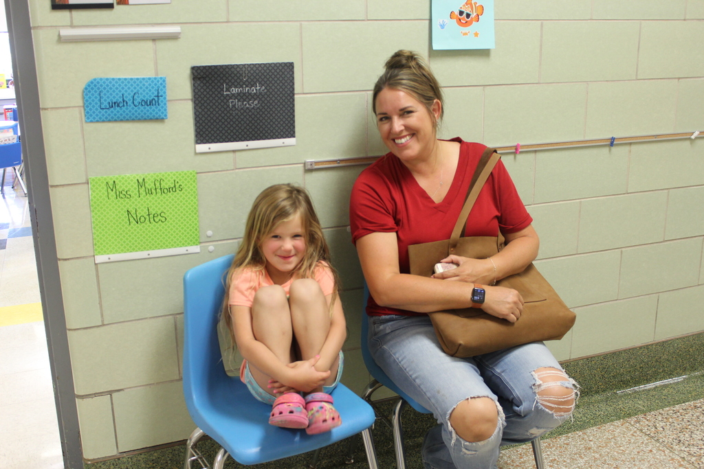 girl and her mother sitting outside classroom