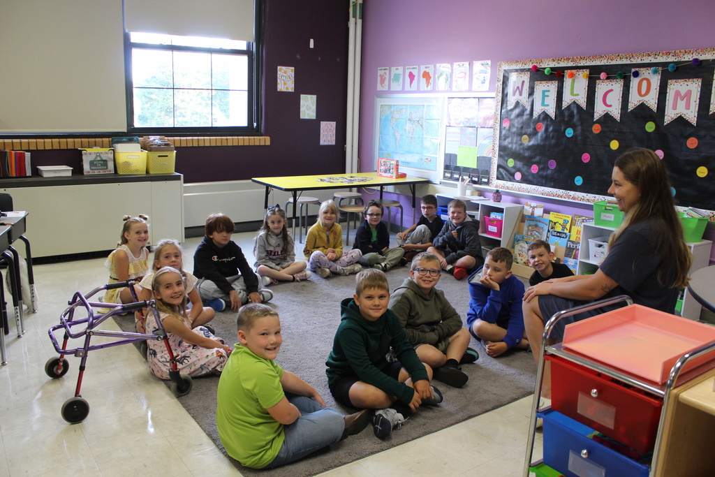 students sitting on the rug in classroom