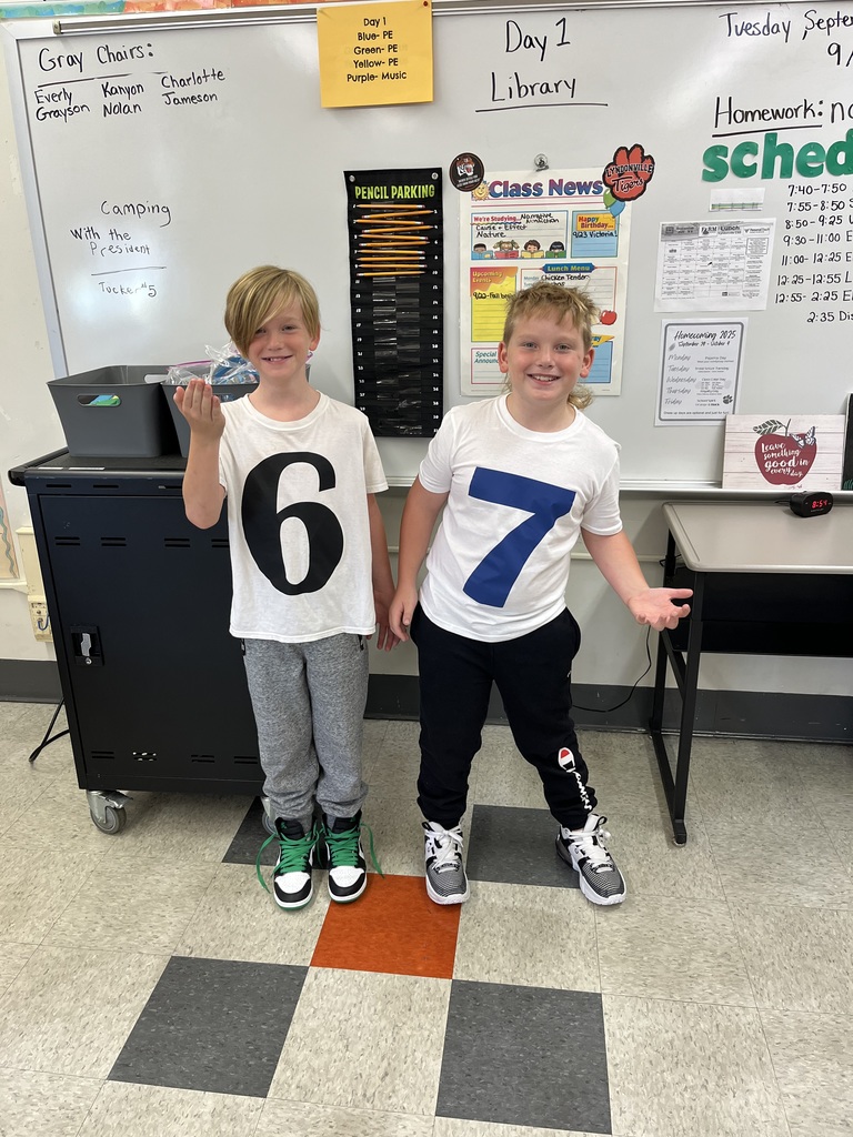 two boys wearing t-shirts with numbers on them
