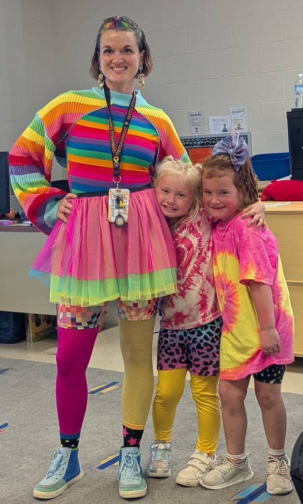 teacher and two students wearing outfits