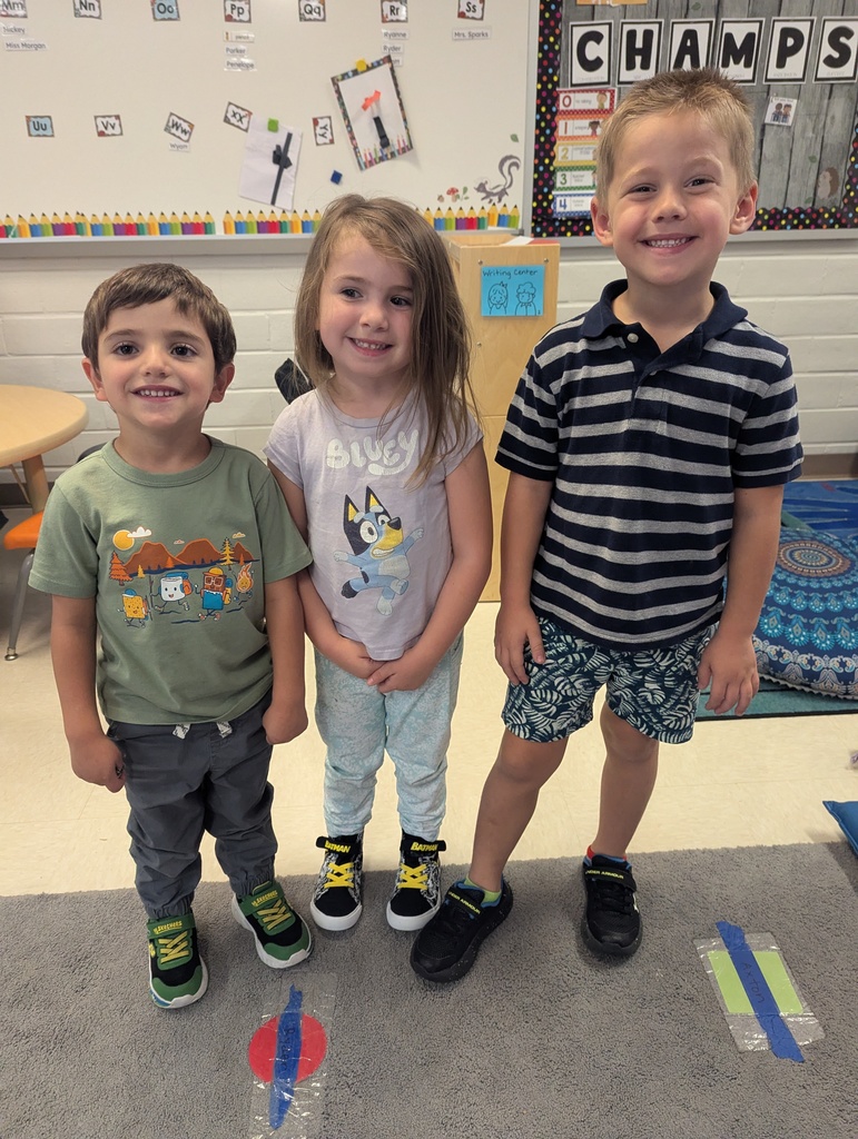 three students wearing outfits