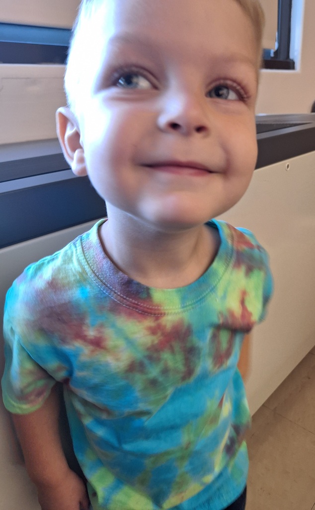 boy wearing tie-dye shirt