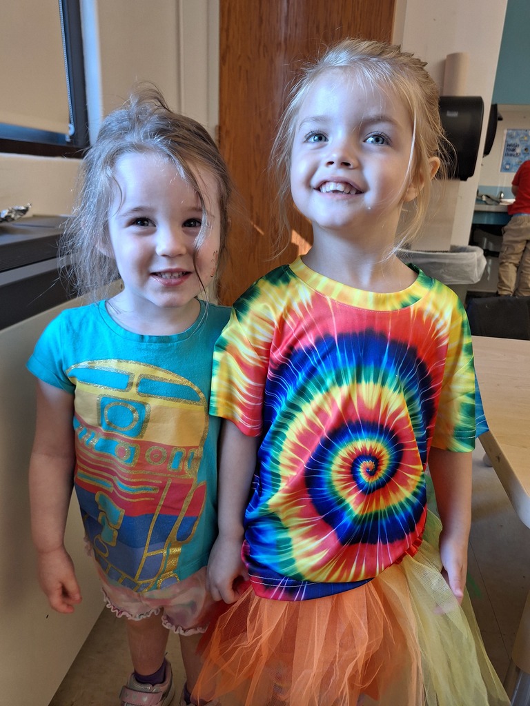 two girls wearing colorful outfits