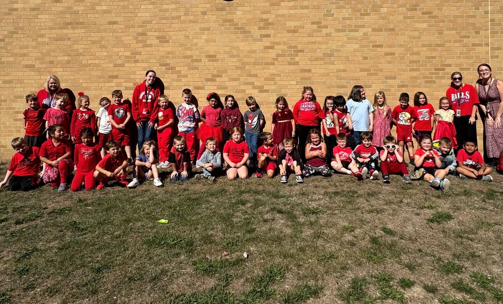 students and staff wearing red in a group