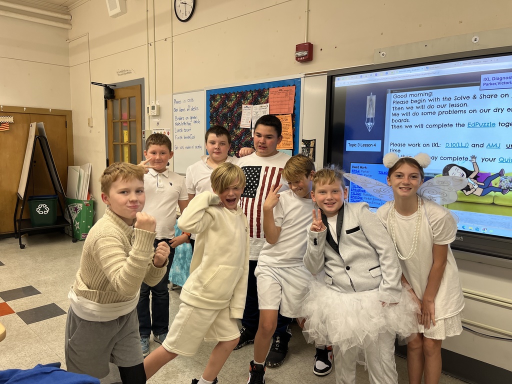 a class of students wearing white outfits
