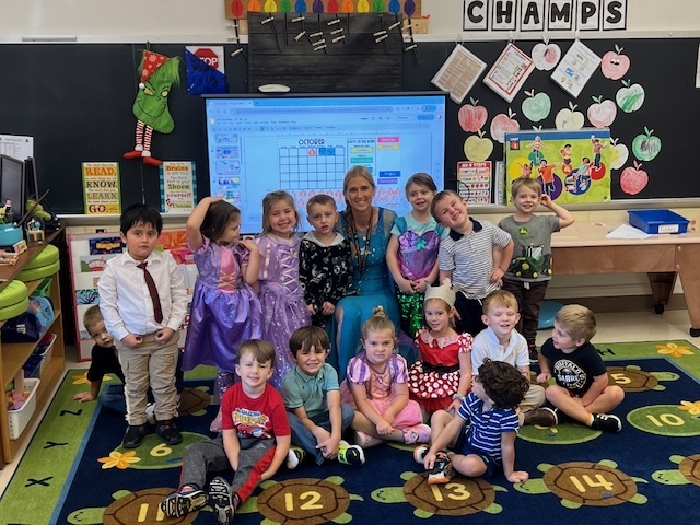 a class with their teacher dressed up in outfits