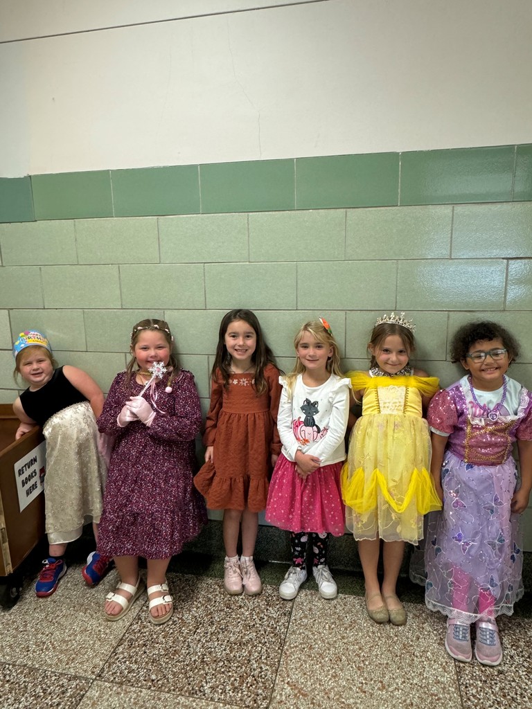 several girls wearing outfits standing together